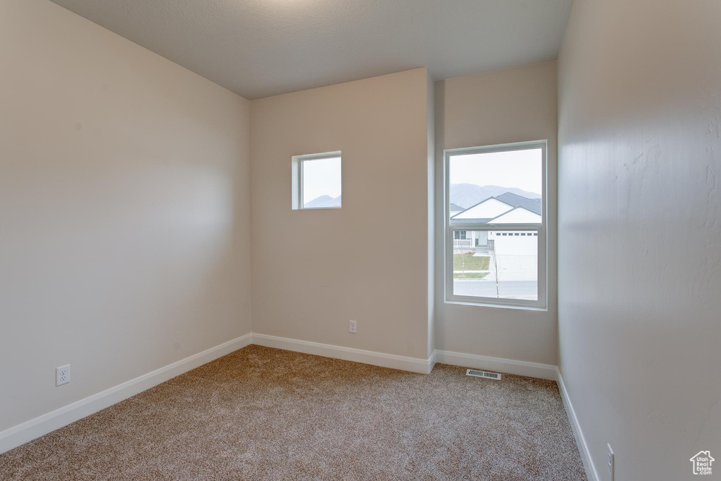 Spare room with light colored carpet