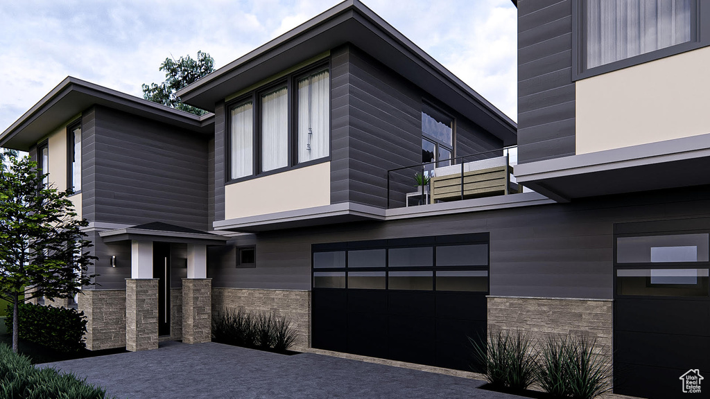 Modern home with a balcony and a garage