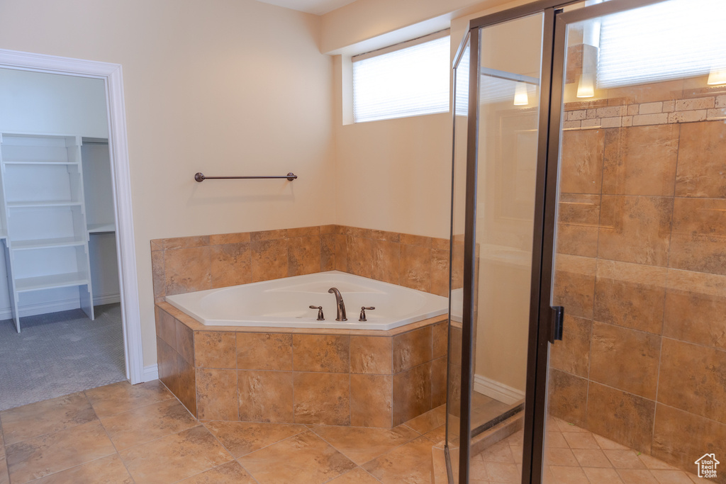 Bathroom with tile floors and plus walk in shower