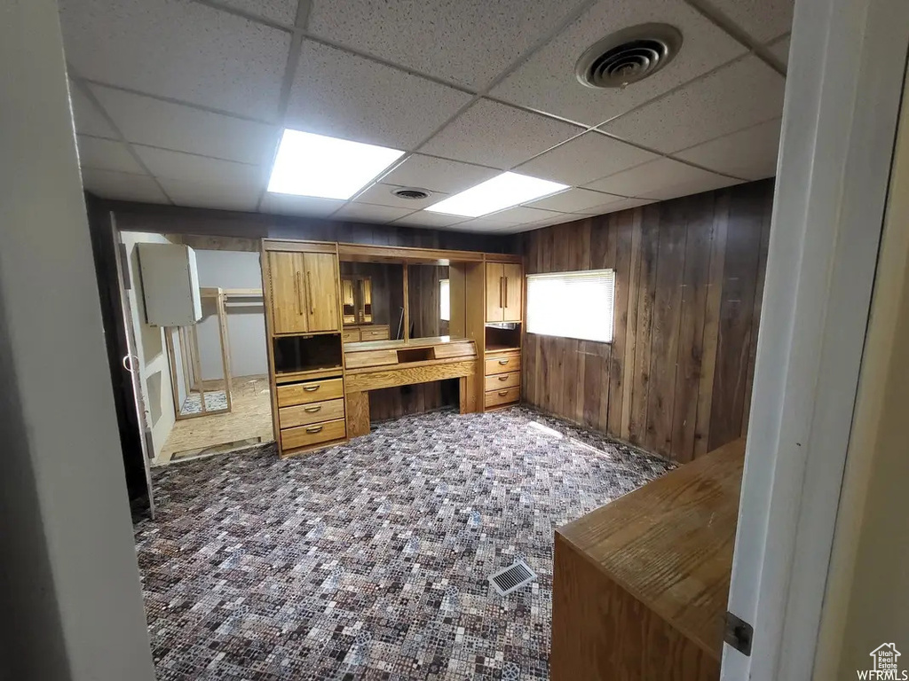 Kitchen with a drop ceiling and carpet flooring