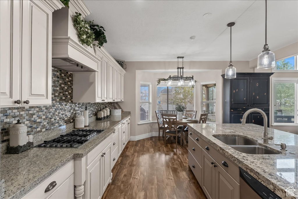 Kitchen featuring premium range hood, decorative light fixtures, dark hardwood / wood-style floors, white cabinets, and stainless steel appliances