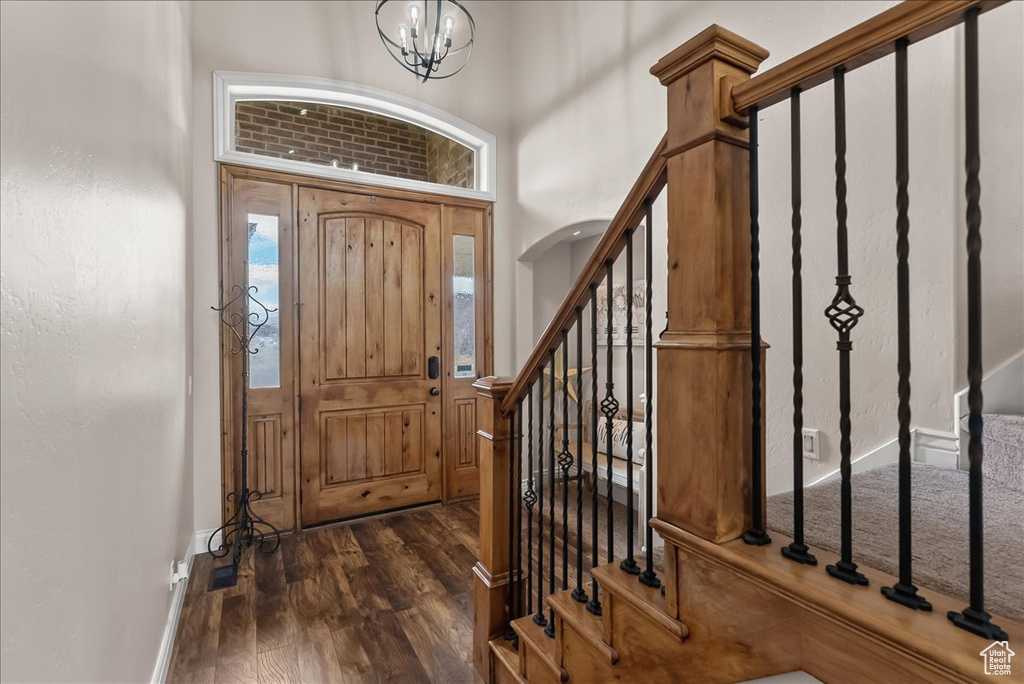 Entryway featuring dark hardwood / wood-style floors and a notable chandelier