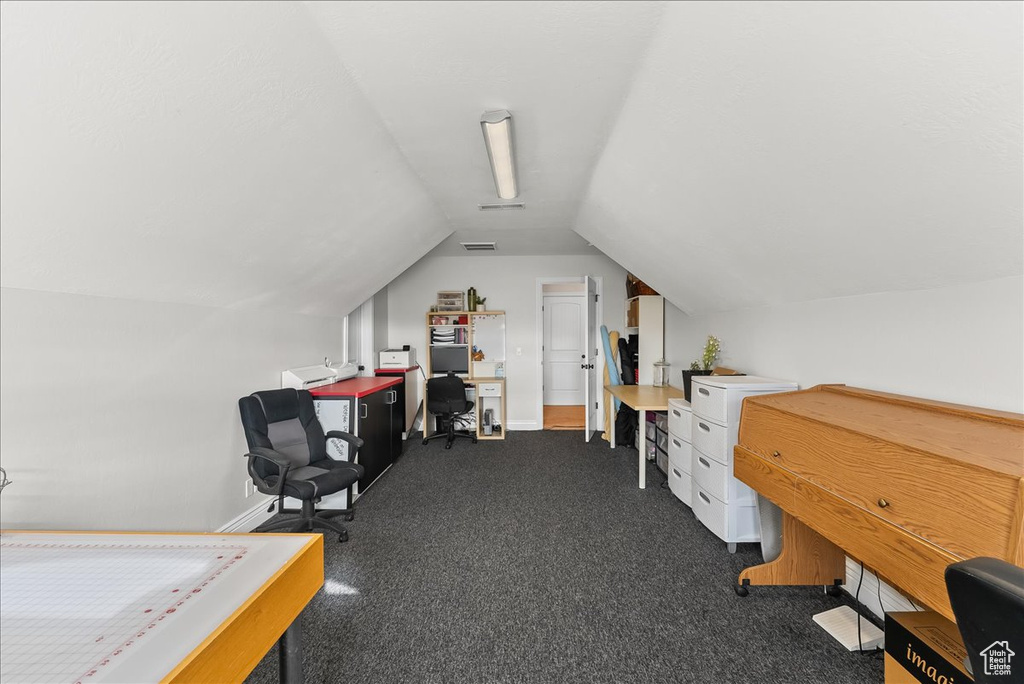 Carpeted office with vaulted ceiling
