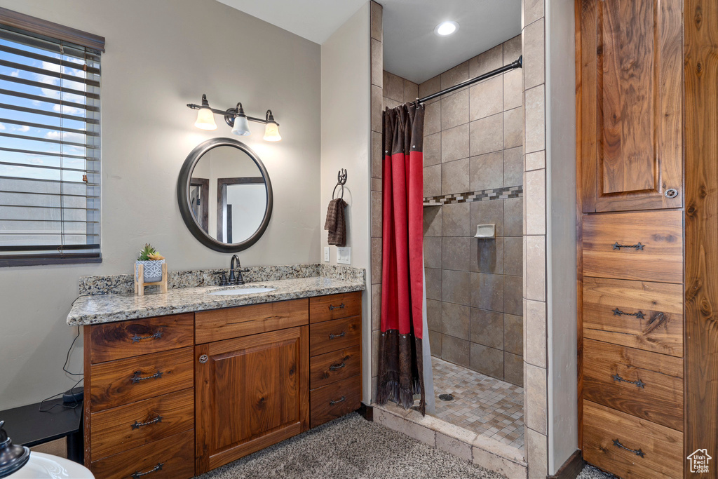 Bathroom featuring vanity and curtained shower