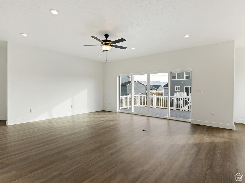 Unfurnished room featuring dark hardwood / wood-style floors and ceiling fan