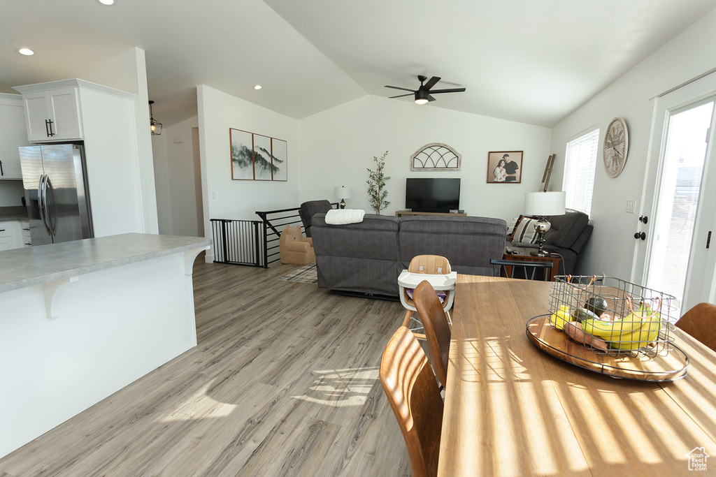 Dining space featuring vaulted ceiling, light hardwood / wood-style floors, and ceiling fan