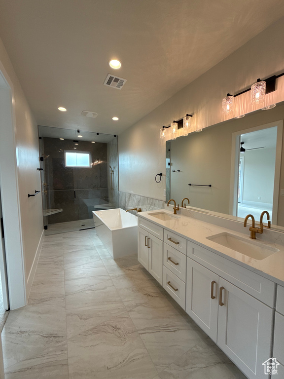 Bathroom with a sink, a soaking tub, marble finish floor, and visible vents