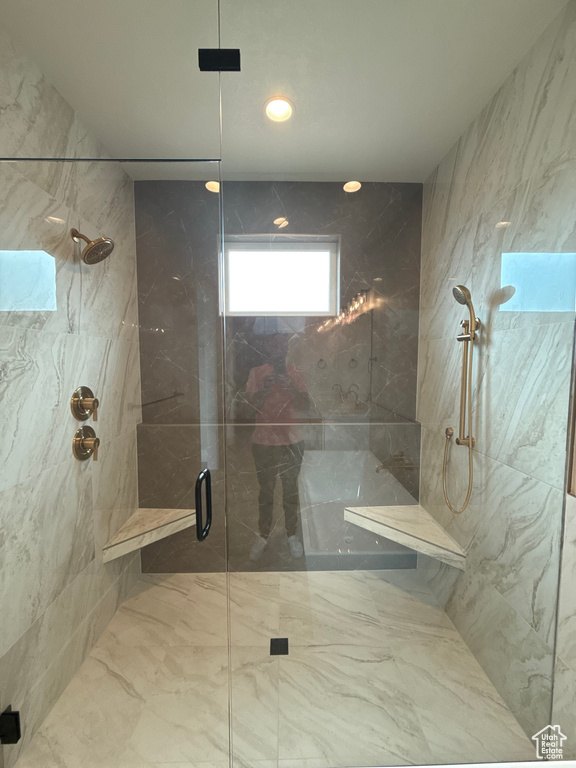 Bathroom featuring a marble finish shower