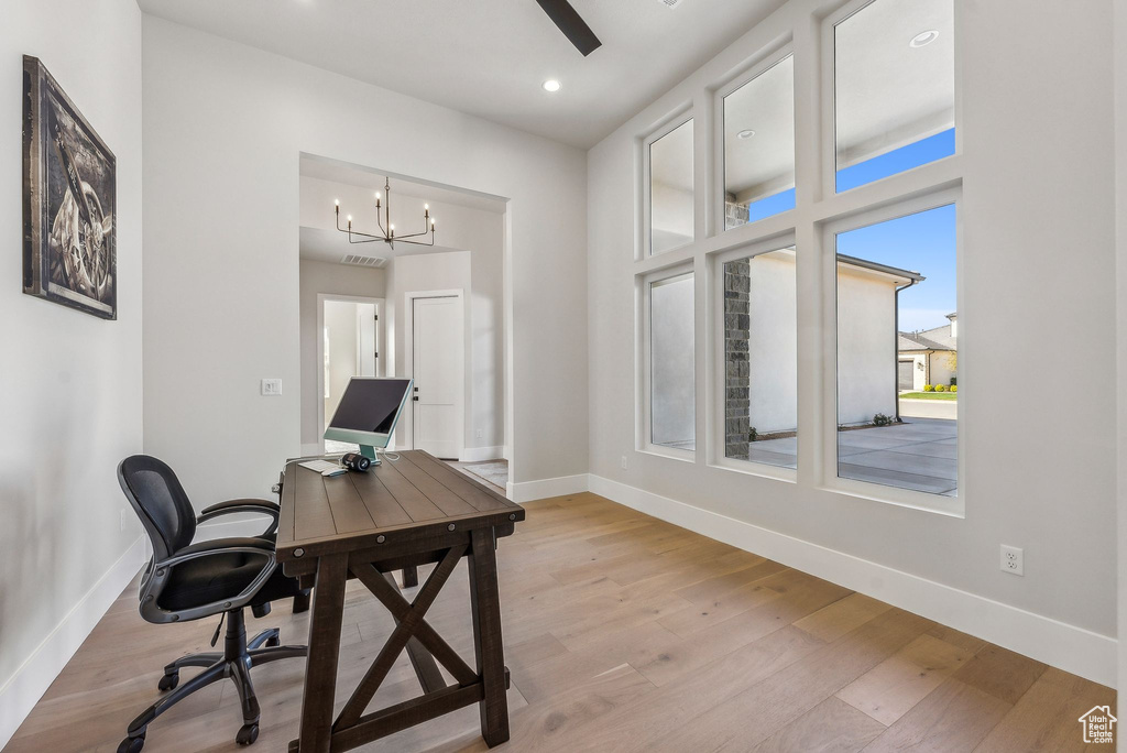Office space featuring baseboards, recessed lighting, light wood finished floors, and a chandelier
