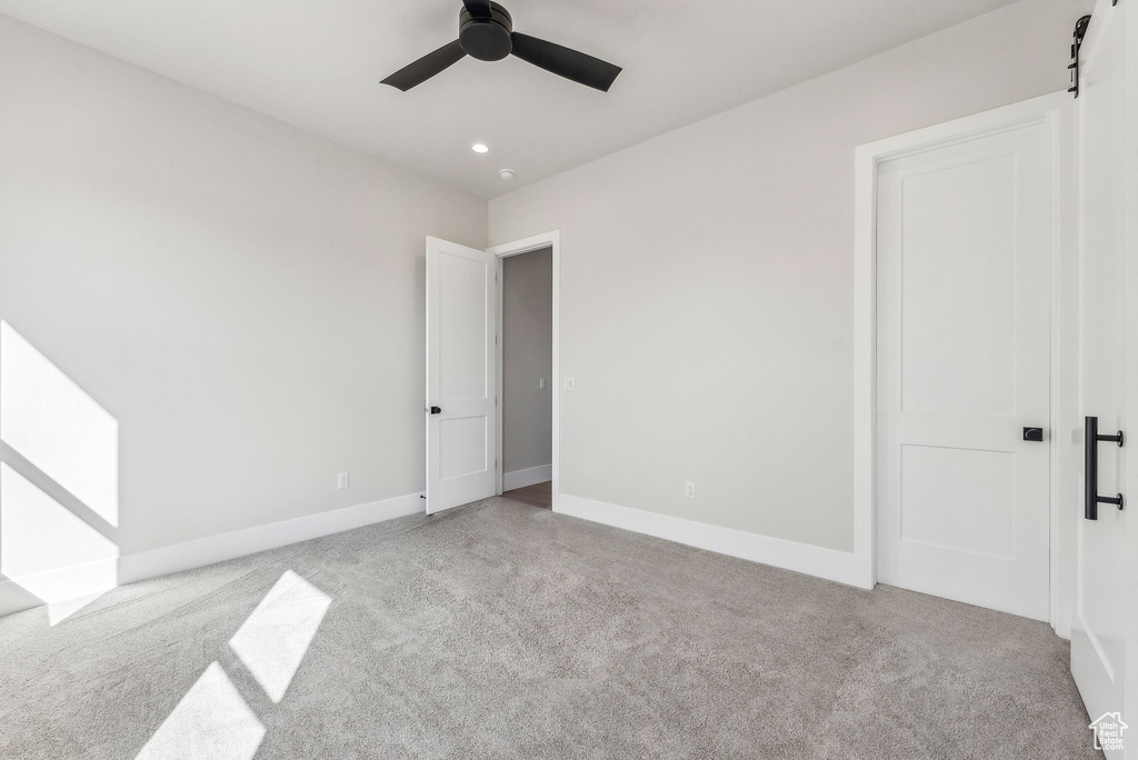 Unfurnished bedroom featuring carpet floors, recessed lighting, baseboards, and a ceiling fan