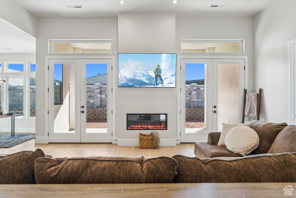 Living area featuring visible vents, french doors, and wood finished floors