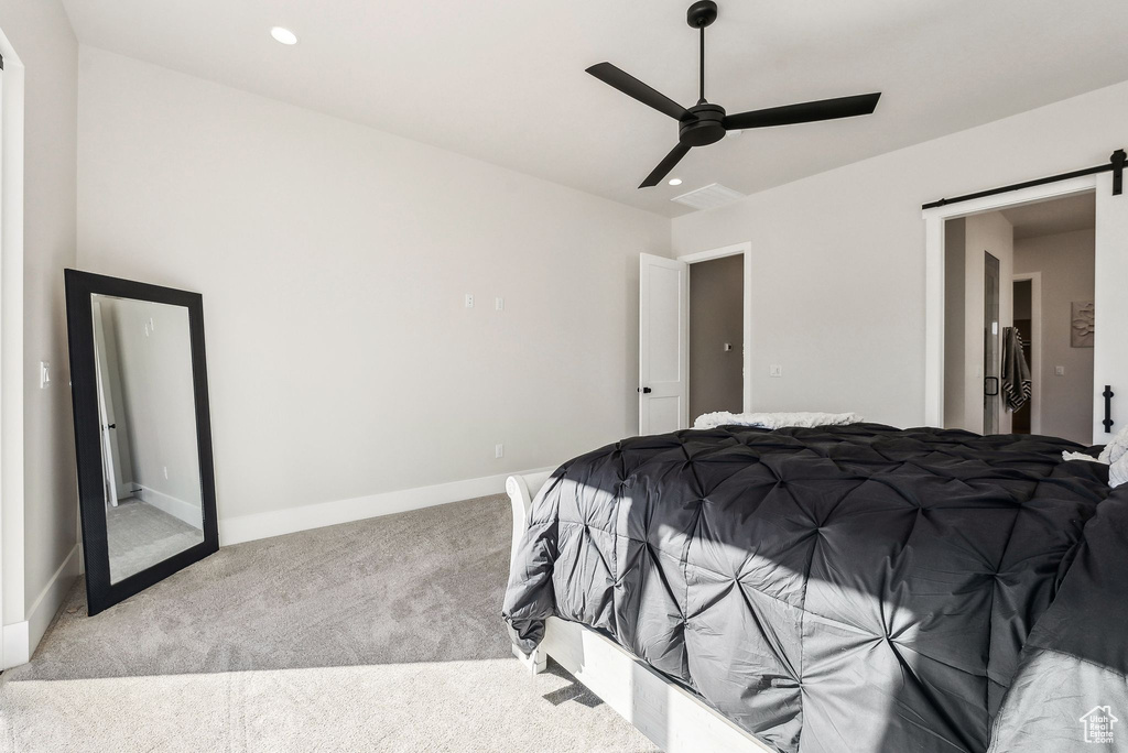 Bedroom with a barn door, carpet floors, a ceiling fan, baseboards, and recessed lighting