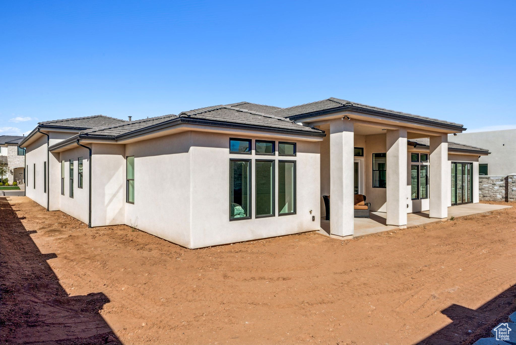 Rear view of property featuring a patio and stucco siding