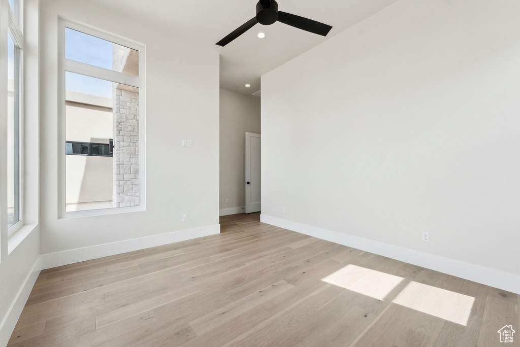 Unfurnished room featuring a ceiling fan, baseboards, recessed lighting, and light wood-style floors