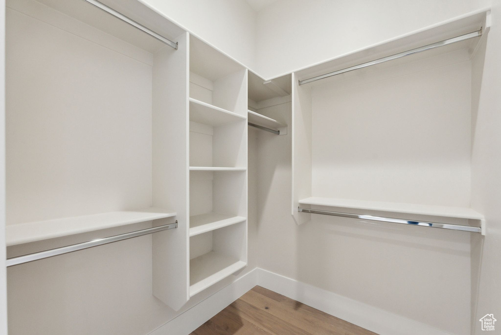 Walk in closet featuring wood finished floors