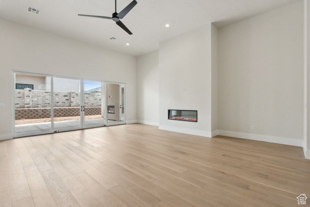 Unfurnished living room with ceiling fan, light wood-style floors, recessed lighting, baseboards, and visible vents