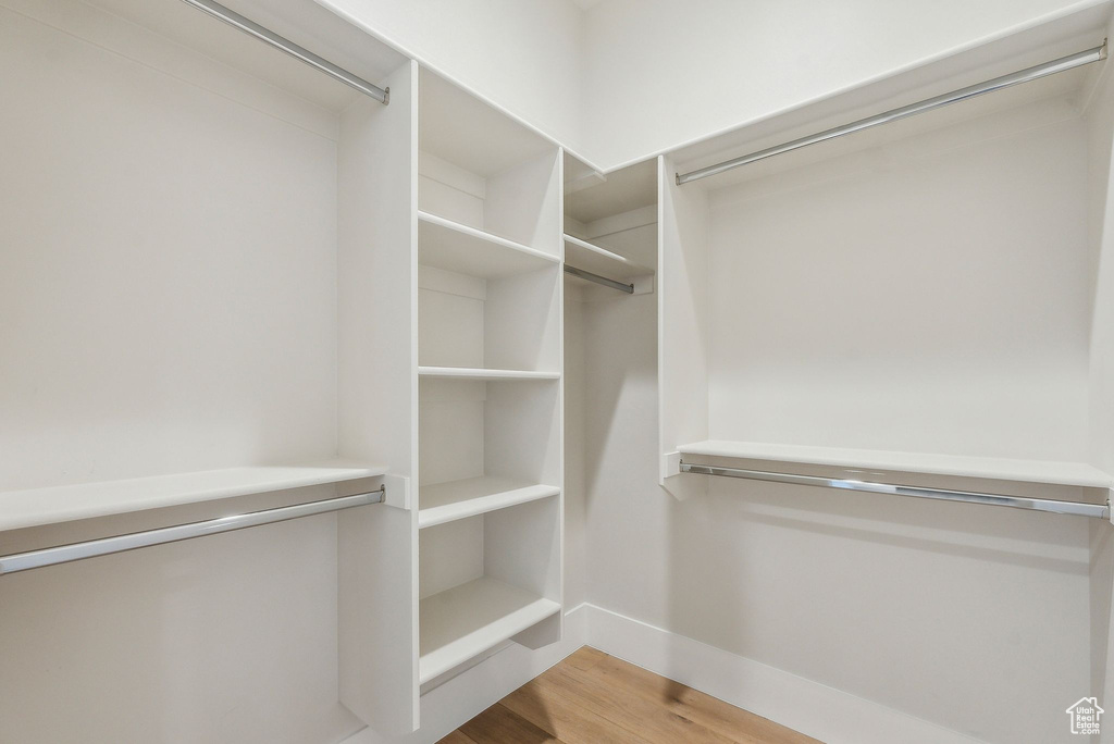 Spacious closet featuring wood finished floors