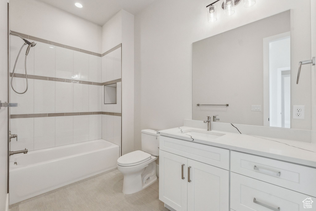 Bathroom with recessed lighting, vanity, shower / bathtub combination, and toilet