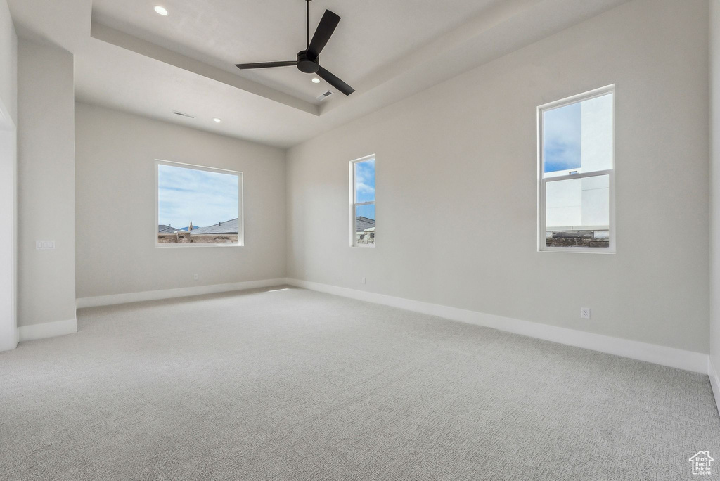 Carpeted empty room with recessed lighting, baseboards, and plenty of natural light