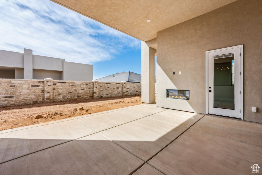 View of patio featuring fence