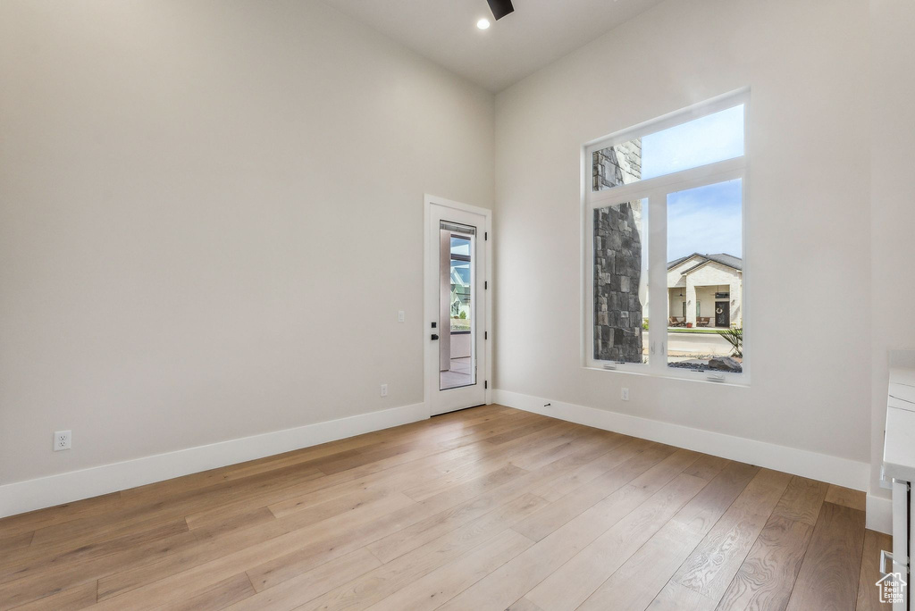 Unfurnished room featuring recessed lighting, baseboards, plenty of natural light, and light wood-style flooring