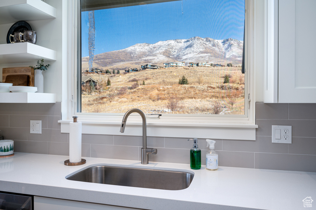 Interior details featuring sink, backsplash, and a mountain view