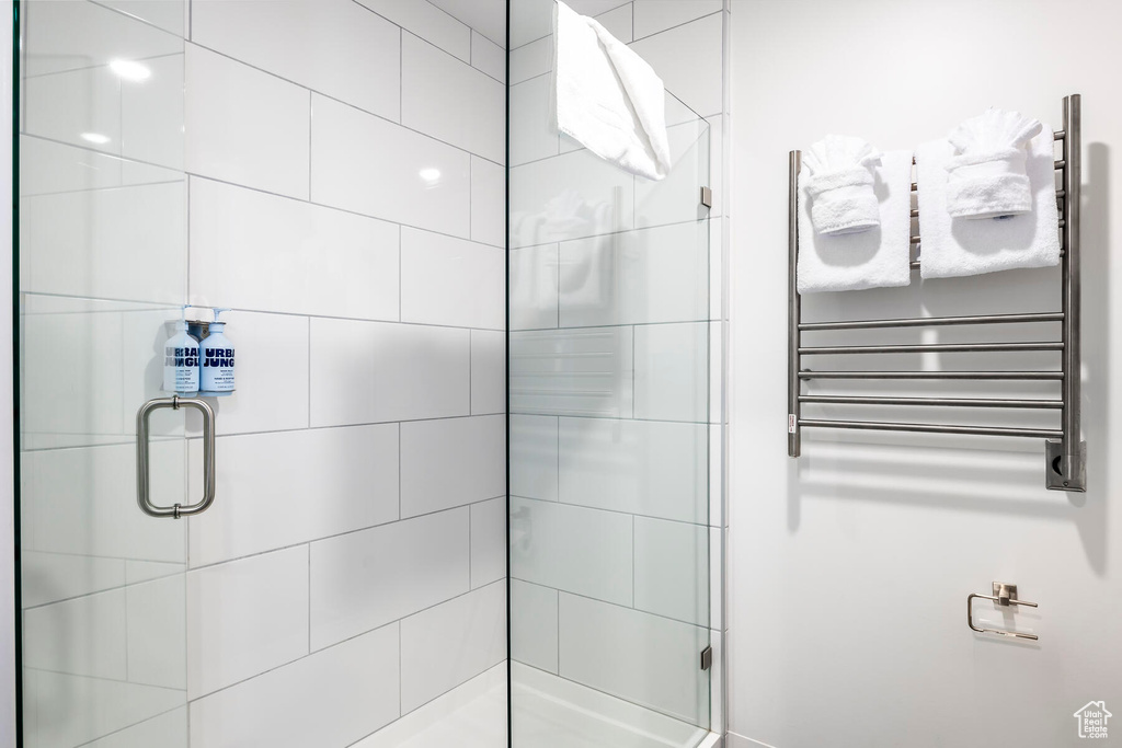 Bathroom featuring radiator and walk in shower