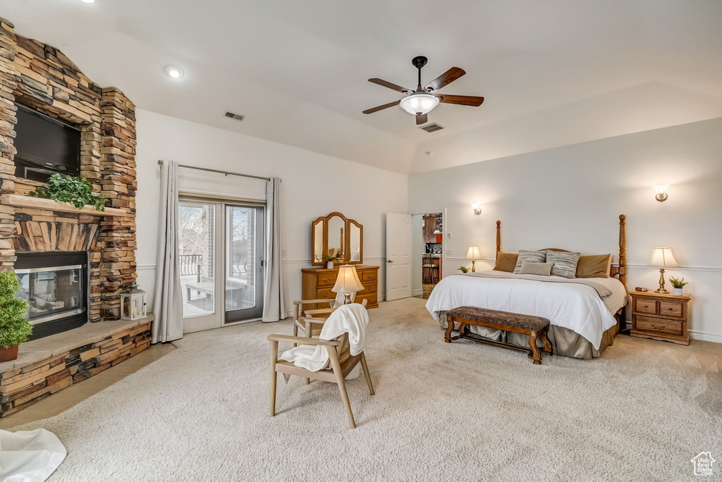 Bedroom with a fireplace, access to exterior, ceiling fan, and light carpet