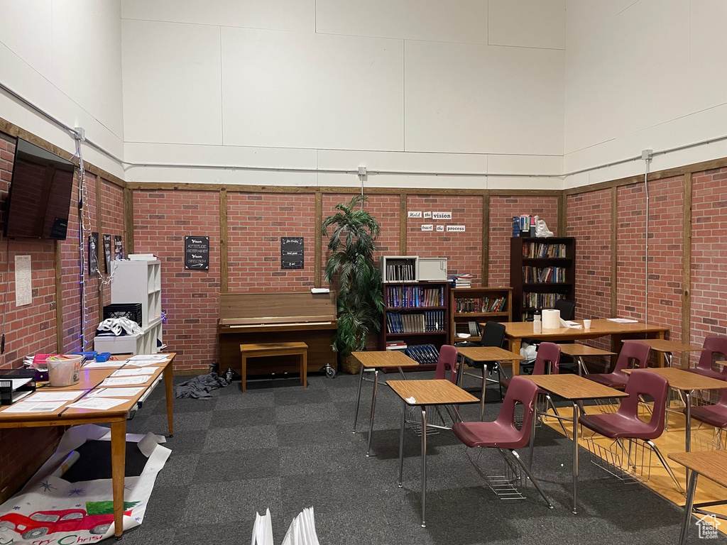 Home office featuring brick wall