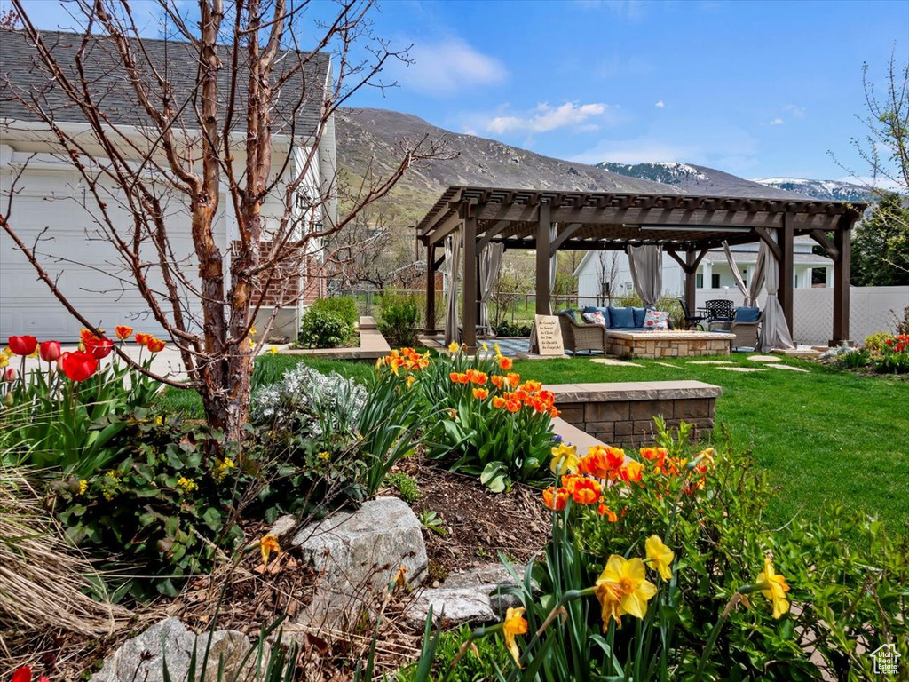 View of yard featuring a mountain view, a patio, a pergola, and an outdoor hangout area