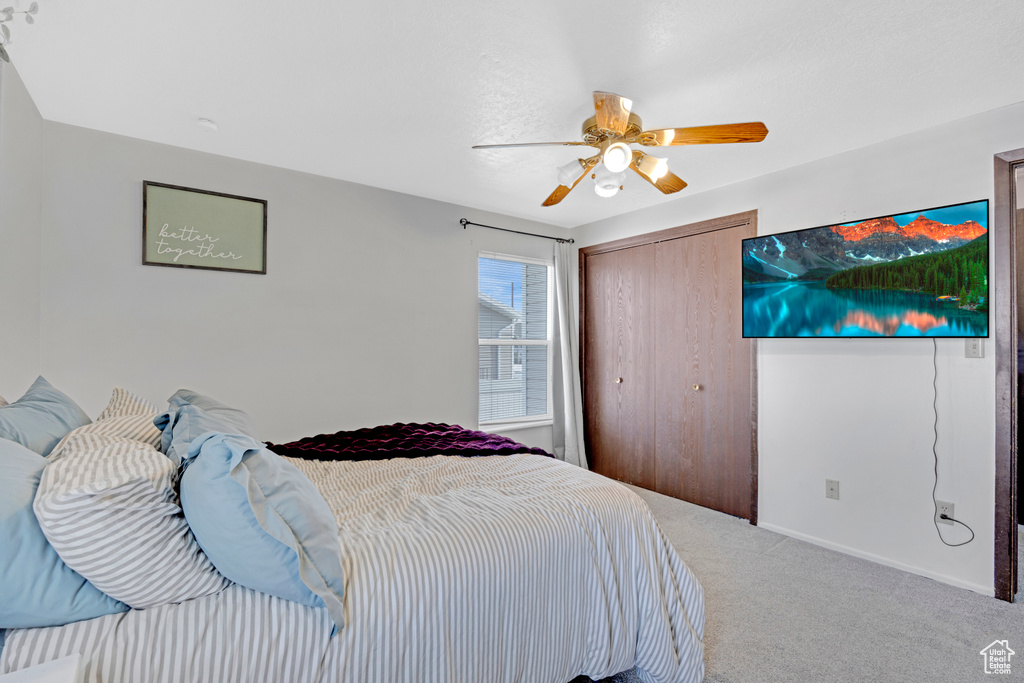 Bedroom featuring carpet, a closet, and ceiling fan