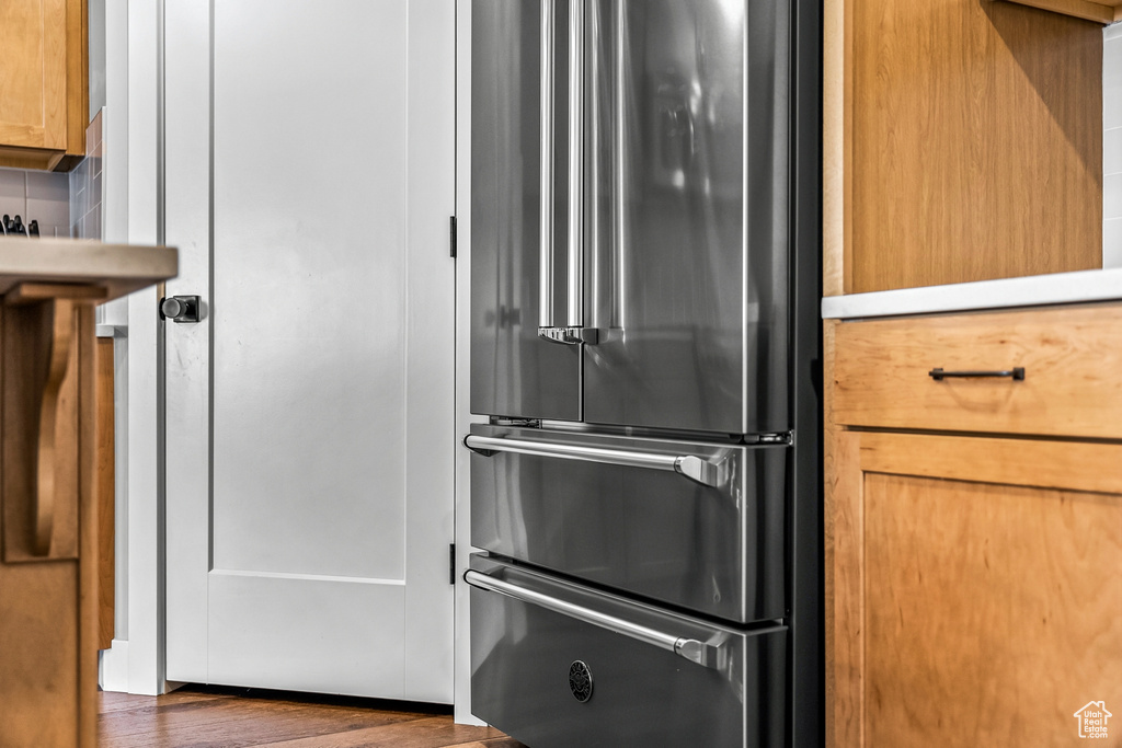 Kitchen featuring dark hardwood / wood-style flooring and high end fridge