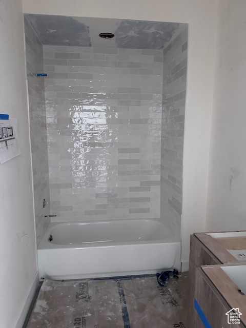 Bathroom featuring vanity and tiled shower / bath combo