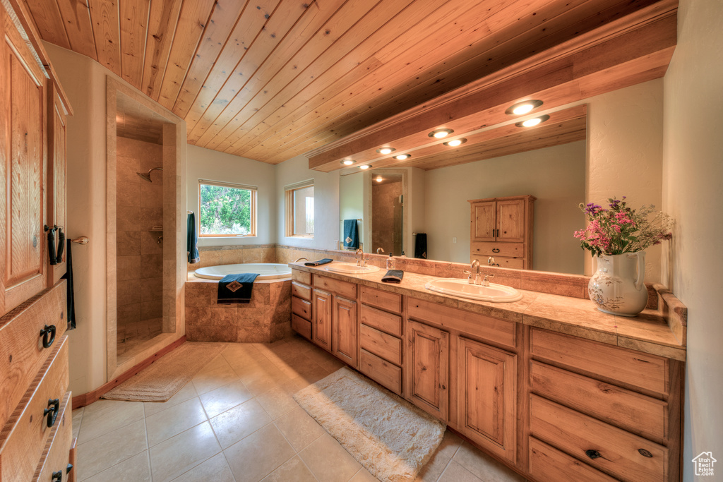 Bathroom featuring double vanity, wooden ceiling, tile flooring, and independent shower and bath