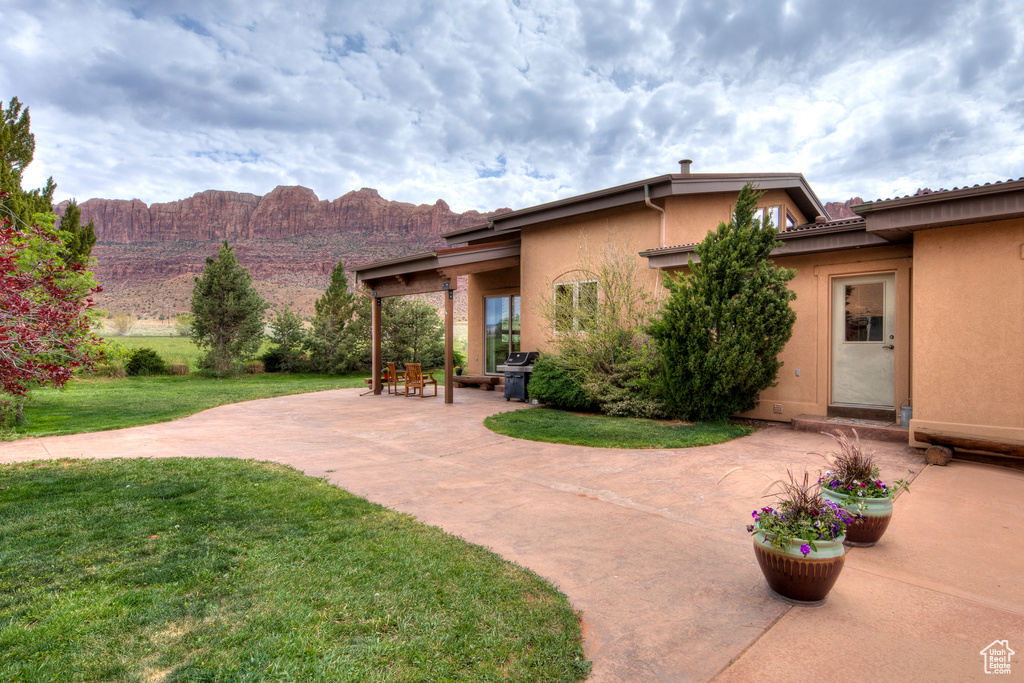 Exterior space featuring a mountain view, a patio, and a front yard