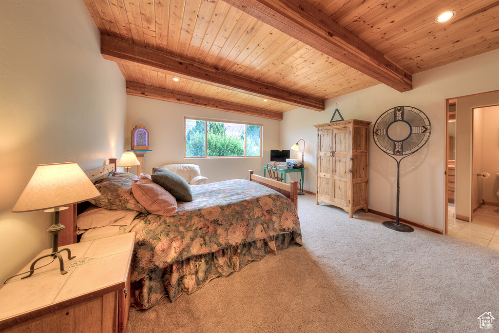 Bedroom with wooden ceiling, beamed ceiling, and light colored carpet