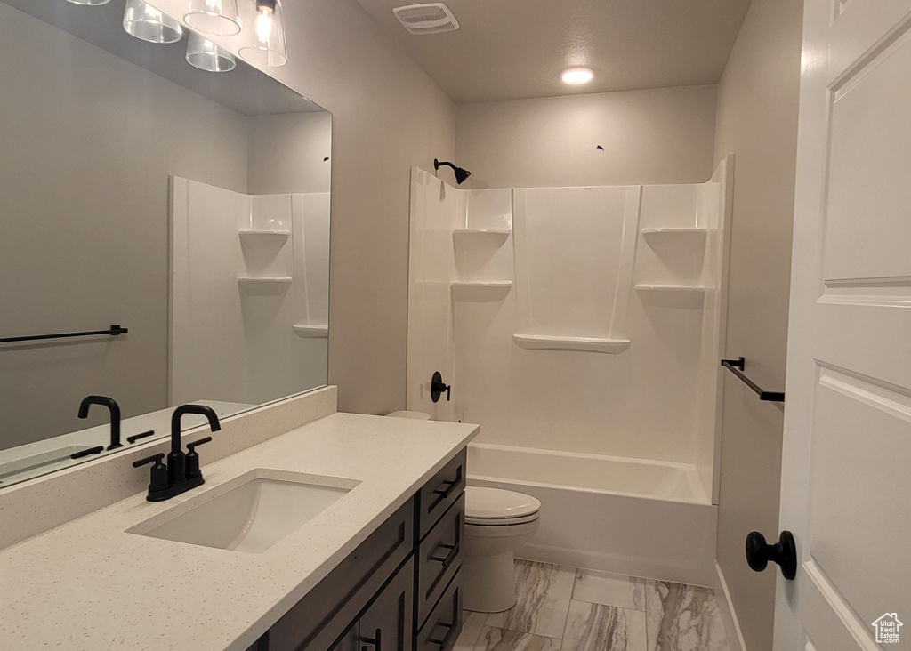 Full bathroom with tile flooring, vanity with extensive cabinet space, bathing tub / shower combination, and toilet