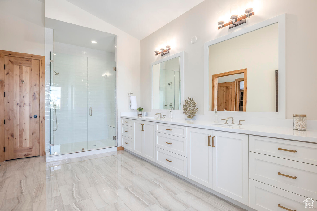 Bathroom with an enclosed shower, vaulted ceiling, tile floors, and oversized vanity