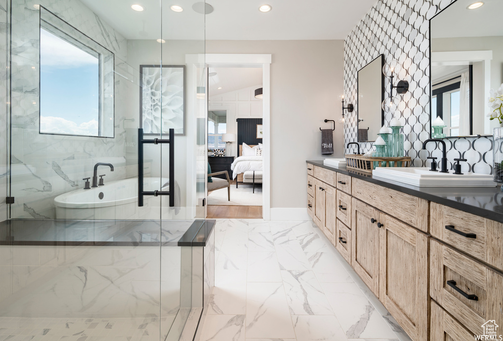 Bathroom featuring vanity, plenty of natural light, tile walls, and hardwood / wood-style flooring