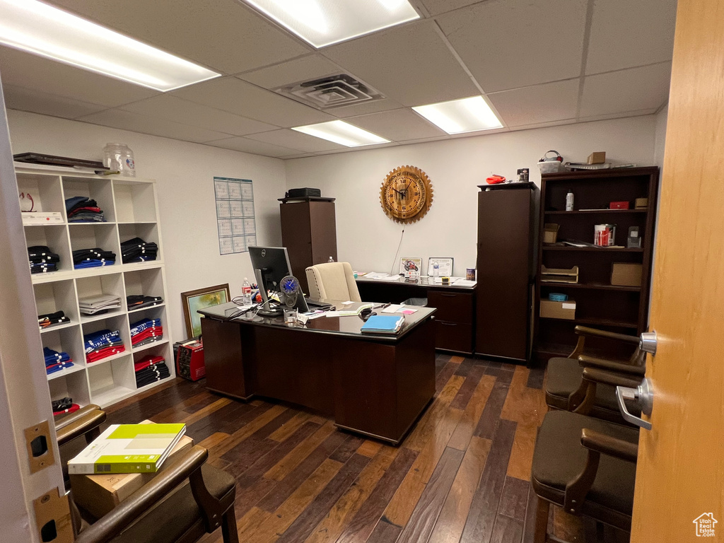 Office featuring dark hardwood / wood-style flooring and a paneled ceiling