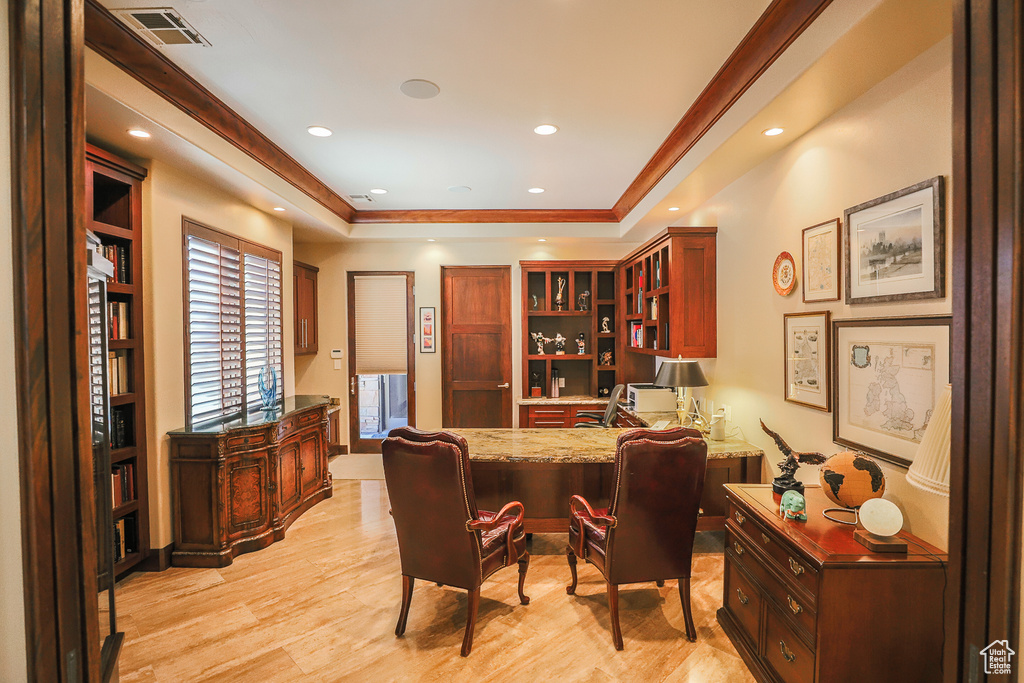 Office featuring light hardwood / wood-style flooring and a raised ceiling