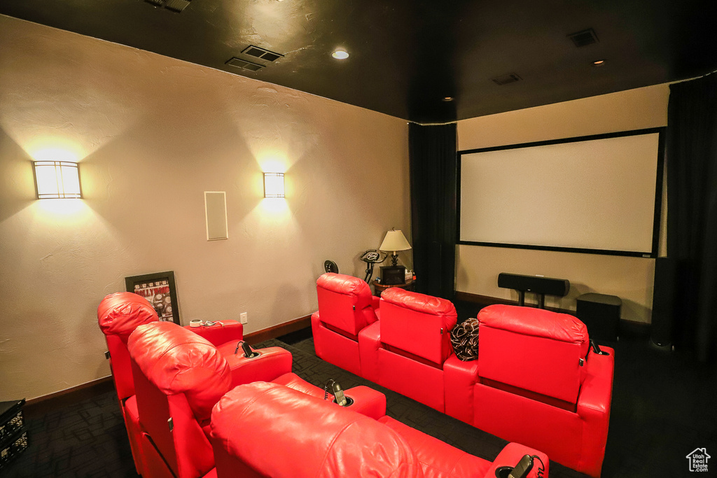 Home theater featuring dark carpet