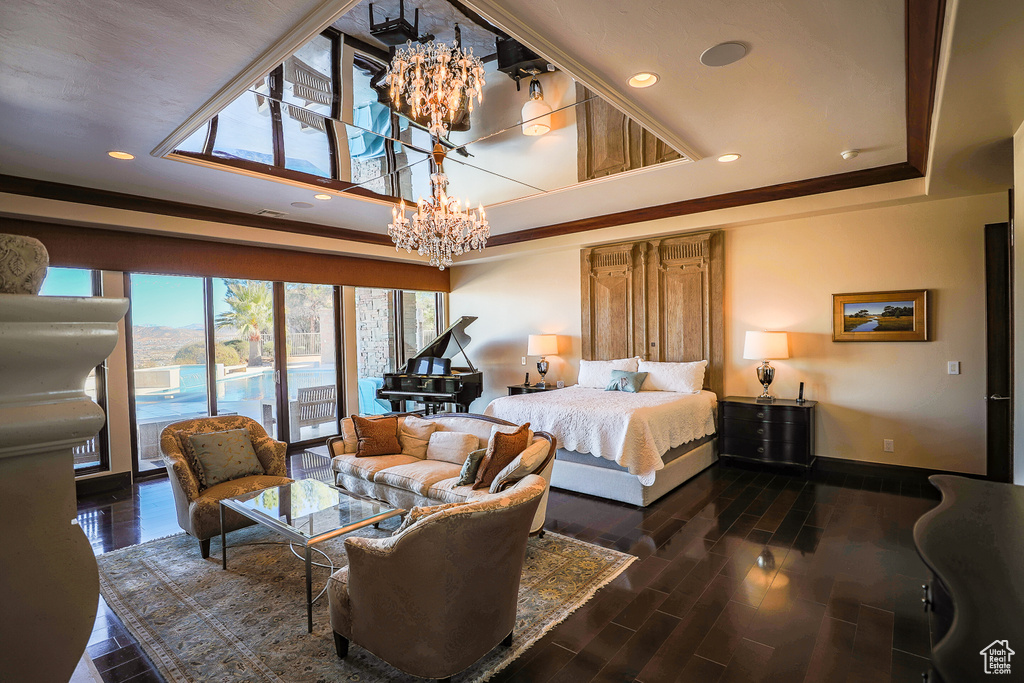 Bedroom with a chandelier, dark hardwood / wood-style flooring, access to outside, and a raised ceiling
