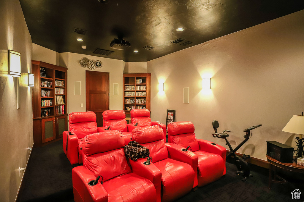 Home theater room with dark colored carpet