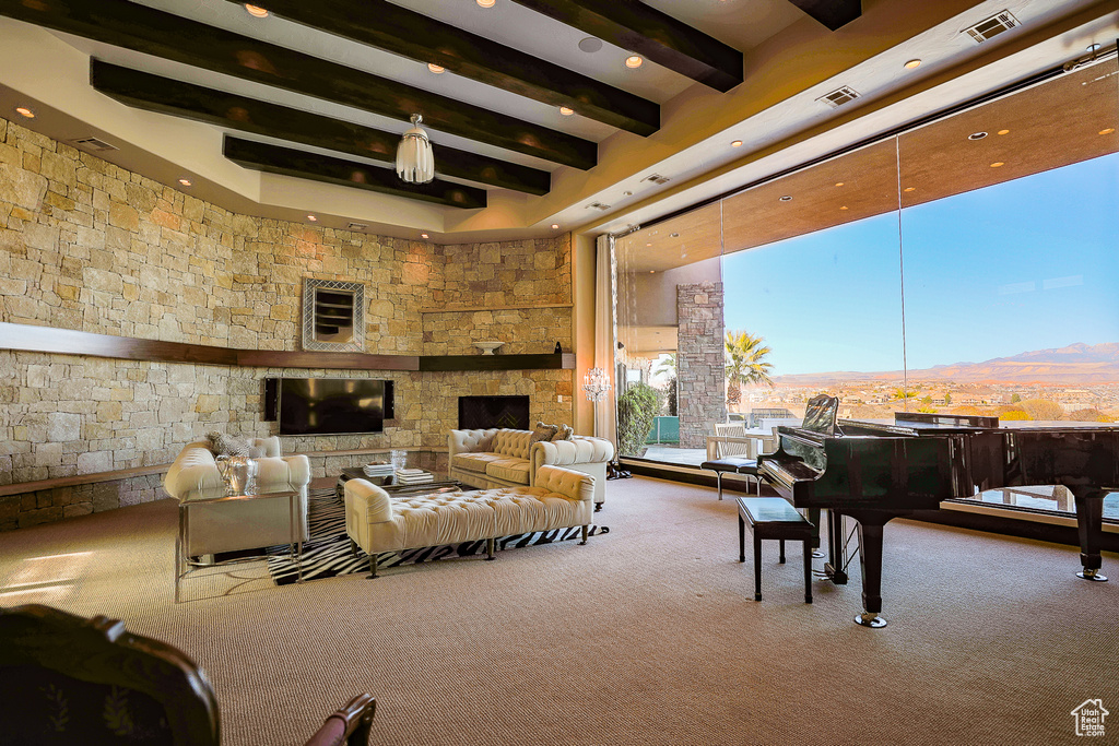 Living room with carpet floors, beamed ceiling, a mountain view, and a fireplace