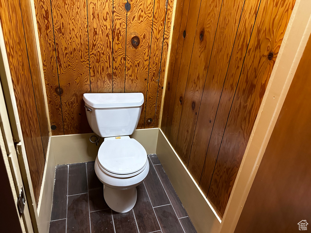 Bathroom with toilet and wooden walls