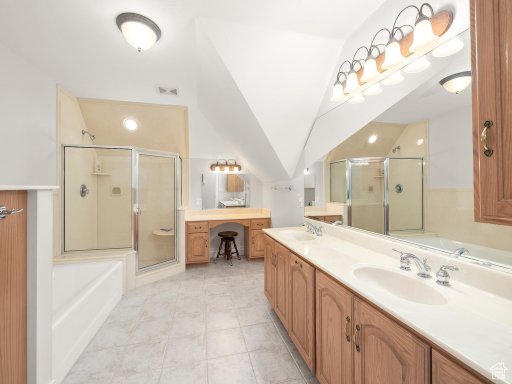 Bathroom featuring dual vanity, tile floors, shower with separate bathtub, and lofted ceiling