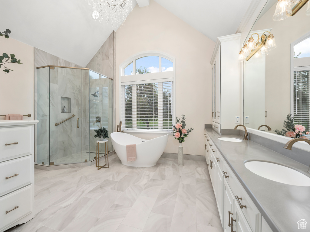 Bathroom featuring double vanity, plus walk in shower, tile flooring, and lofted ceiling