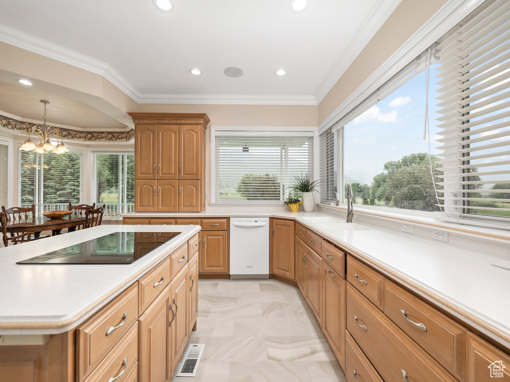 Kitchen with sink, light tile floors, a notable chandelier, and a healthy amount of sunlight