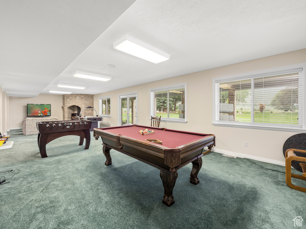Rec room featuring billiards, a fireplace, and carpet flooring